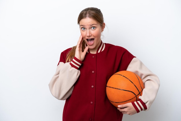 Young basketball player woman isolated on white background with surprise and shocked facial expression