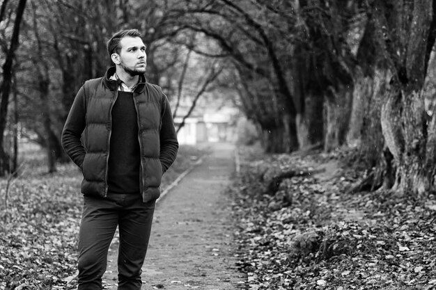 Young beard man in a autumn park