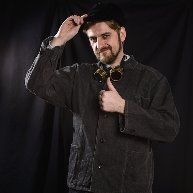 Young beard worker welder going thumb up