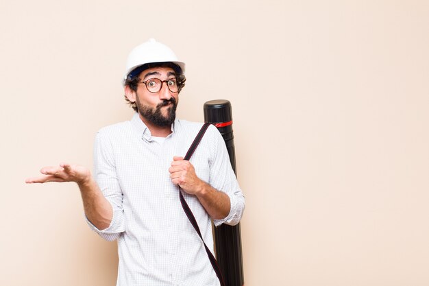 Young  bearded architect man confused or thinking