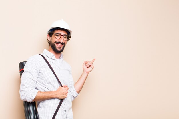 Young  bearded architect man pointing to the side