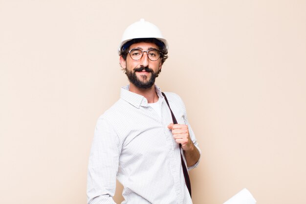 Young  bearded architect man proud pose with a copy space