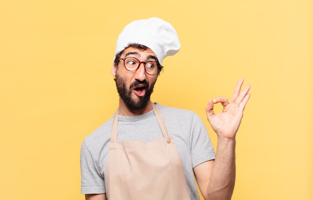 Young bearded chef man happy expression