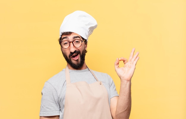 Young bearded chef man happy expression