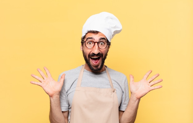 Young bearded chef man surprised expression