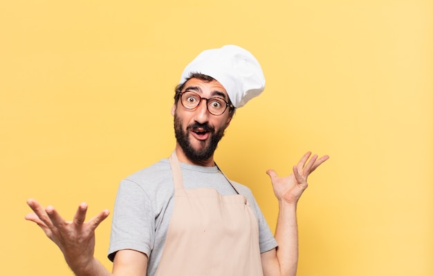 Young bearded chef man surprised expression