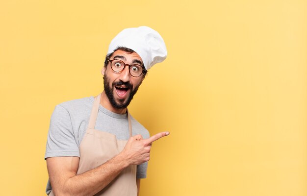 Young bearded chef man surprised expression