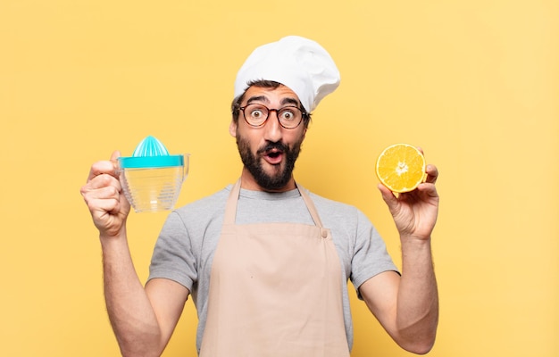 Young bearded chef man surprised expression