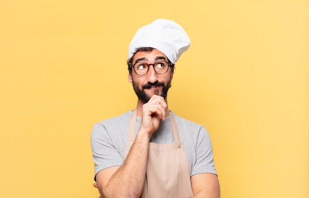 Young bearded chef man thinking expression