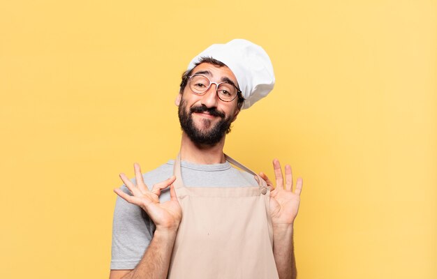 Foto giovane chef barbuto con espressione felice