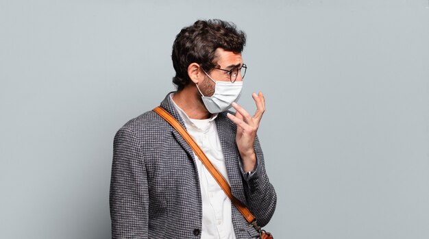 Young bearded crazy businessman with a covid mask