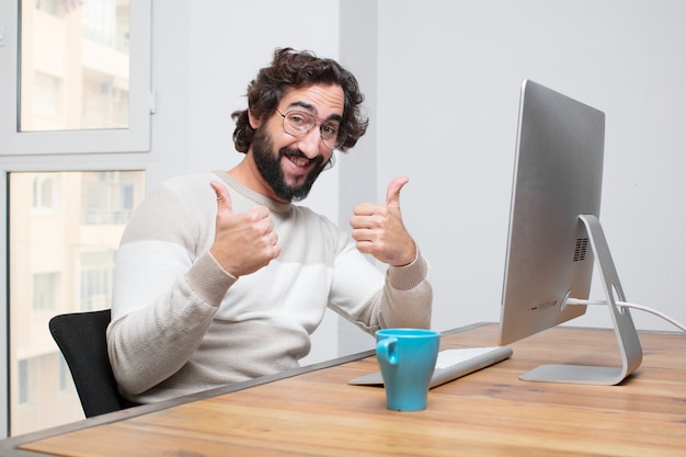 Young bearded crazy freelancer working with his computer