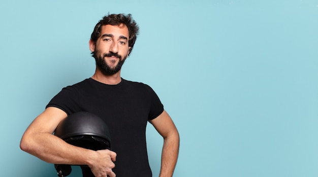 Young bearded crazy man with a motorbike helmet