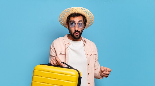 Young bearded crazy man with yellow trolley