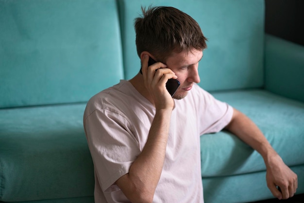 A young bearded guy making a phone call