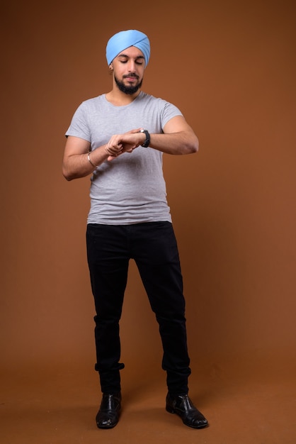 Young bearded Indian Sikh man wearing turban