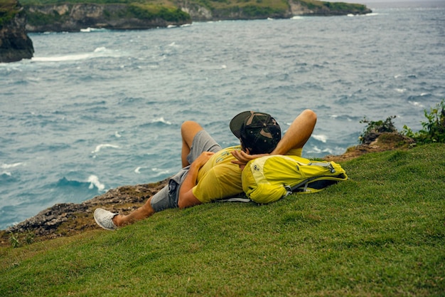 young bearded male traveler on the ocean