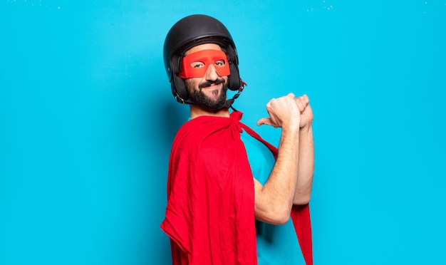 Photo young bearded man. crazy and humorous super hero with helmet and mask