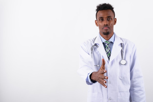 Young bearded man doctor against white