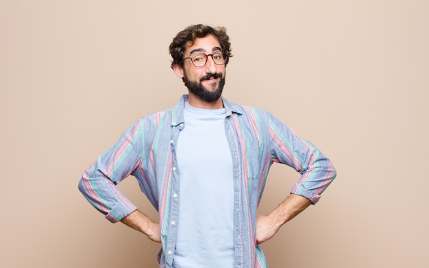 Young bearded man on flat wall