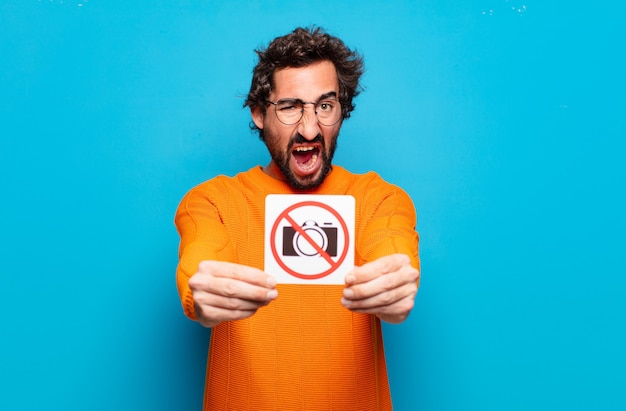 Young bearded man forbidden photo concept