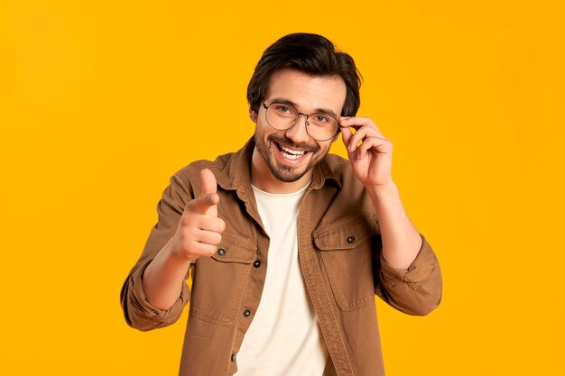 Young bearded man in glasses shows a finger, saying