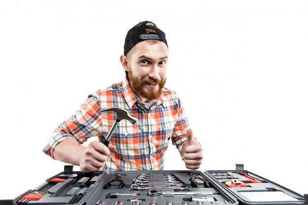 The young bearded man hold a repair tools