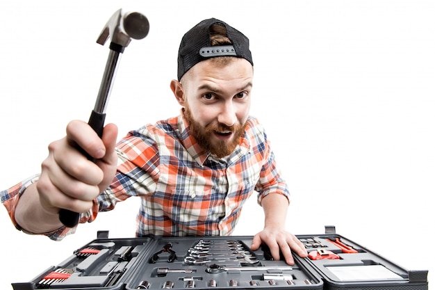 Photo the young bearded man hold a repair tools