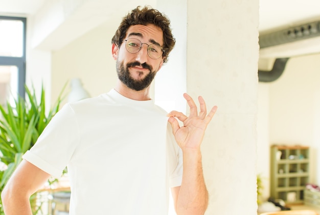 Young bearded man at home. proud expression