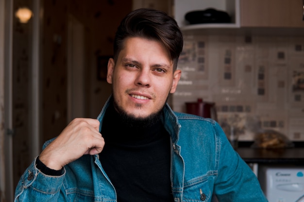 Young bearded man in jeans jacket