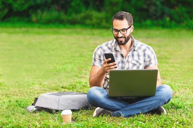 Young bearded man in plaid shirt