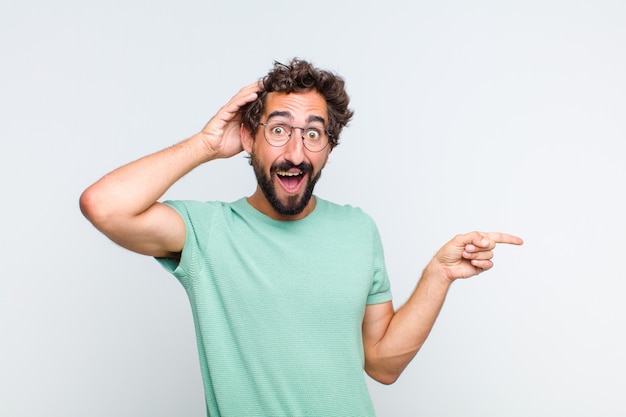 Young bearded man pointing