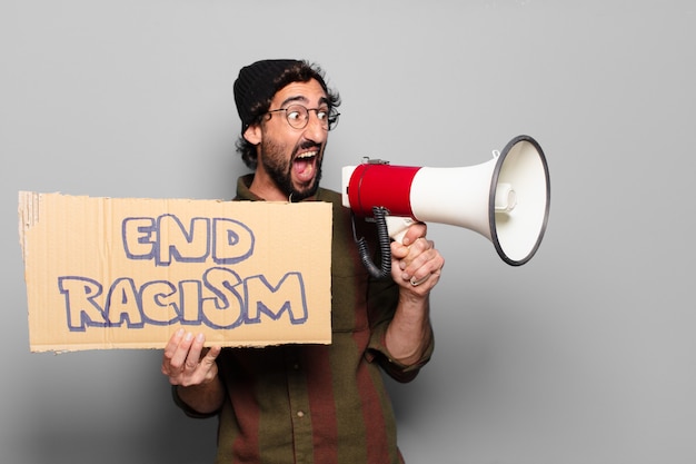 Young bearded man protesting with a megaphone