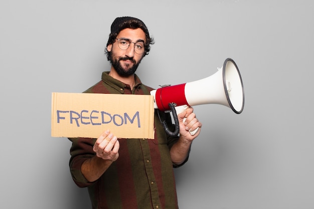 young bearded man protesting with a megaphone