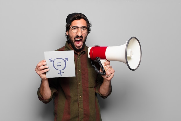 Young bearded man protesting with a megaphone