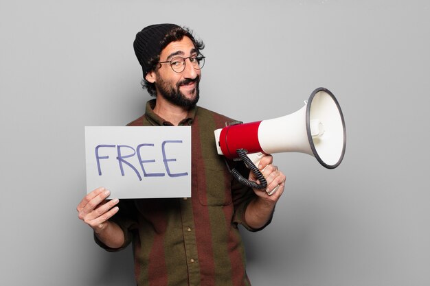 Young bearded man protesting with a megaphone