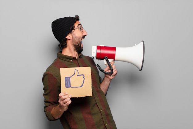 Young bearded man protesting with a megaphone