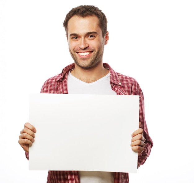 Young bearded man showing blank signboard