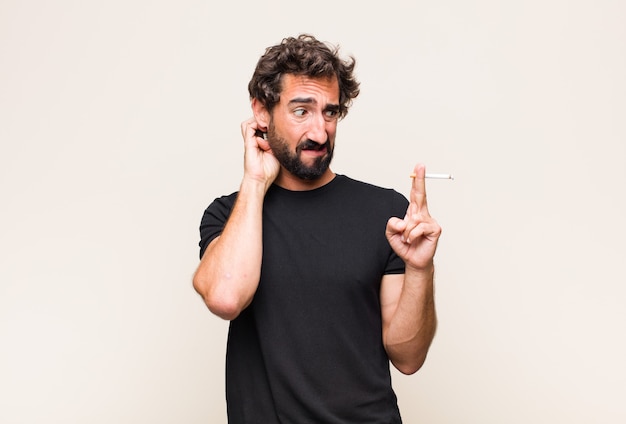 Young bearded man smoking a cigarette