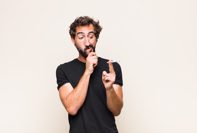 Young bearded man smoking a cigarette