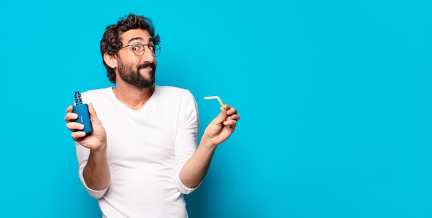 Young bearded man smoking with a vaper