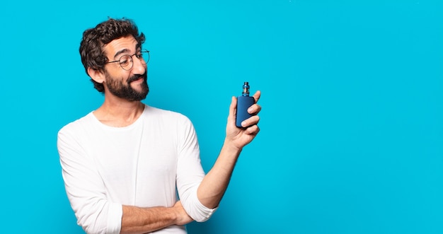 Young bearded man smoking with a vaper