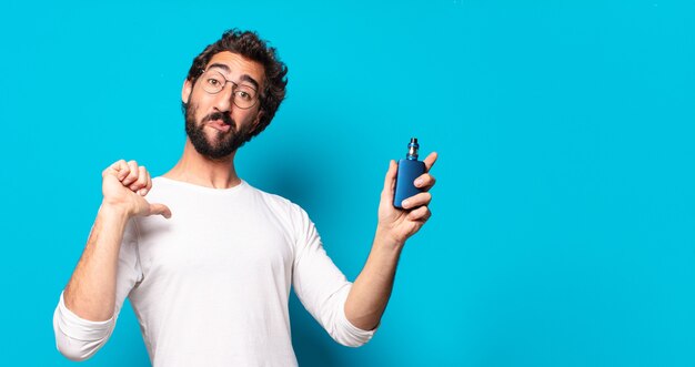 Young bearded man smoking with a vaper