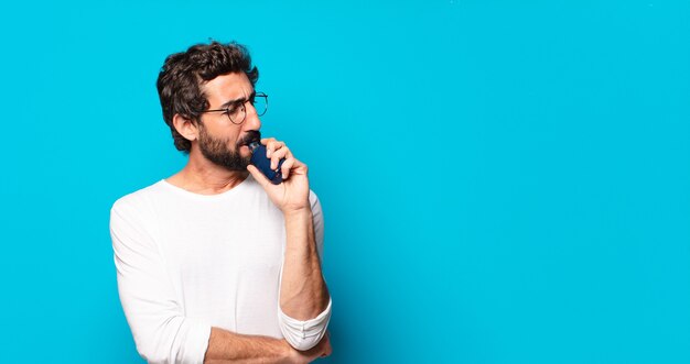 Young bearded man smoking with a vaper