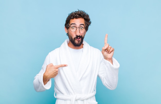 Young bearded man wearing a bath robe