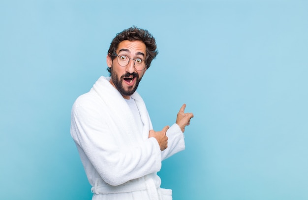 Young bearded man wearing a bath robe