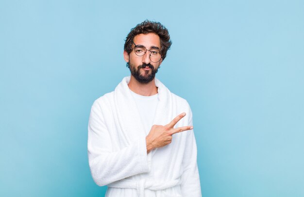 Young bearded man wearing a bath robe