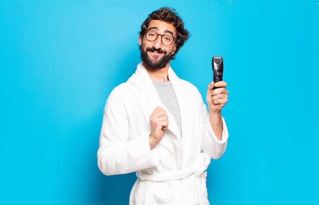 Young bearded man wearing bathrobe. hair or beard care concept