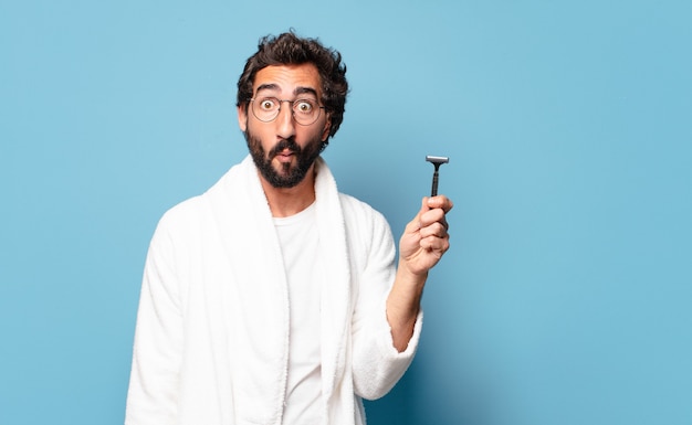 Young bearded man wearing bathrobe. shaving concept