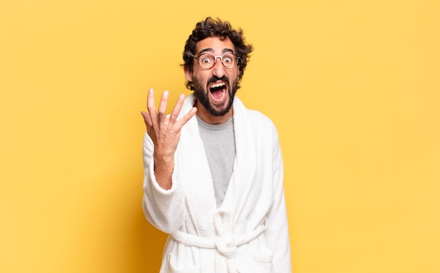 Young bearded man wearing bathrobe